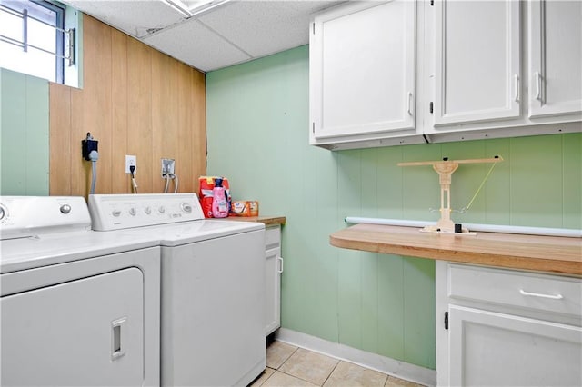 1211 SW Walnut St, Lees Summit, MO 64081 - laundry area with washing machine and dryer, cabinet space, light tile patterned floors, and wood walls