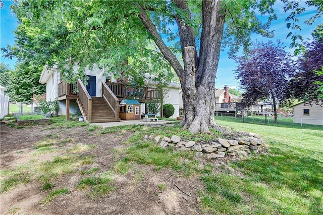 1211 SW Walnut St, Lees Summit, MO 64081 - view of yard featuring stairs, a wooden deck, and a patio area