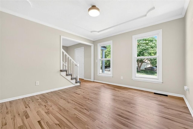 2623 W 131st St, Olathe, KS 66061 - spare room featuring wood finished floors, ornamental molding, and stairs