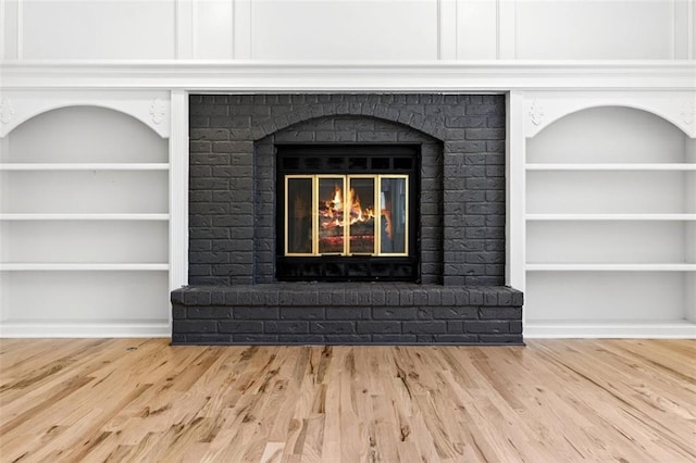 2623 W 131st St, Olathe, KS 66061 - detailed view of a fireplace, wood finished floors, and built in features