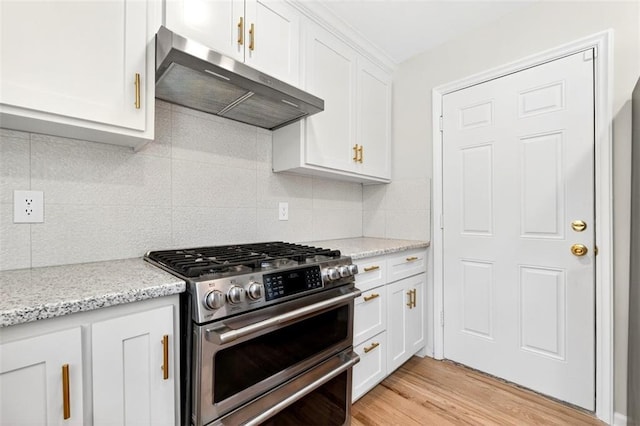 2623 W 131st St, Olathe, KS 66061 - kitchen with range with two ovens, range hood, white cabinets, and tasteful backsplash