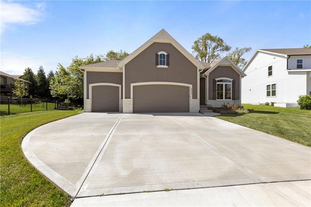 25313 W 142nd Pl, Olathe, KS 66061 - view of front of property with stucco siding, driveway, stone siding, and an attached garage