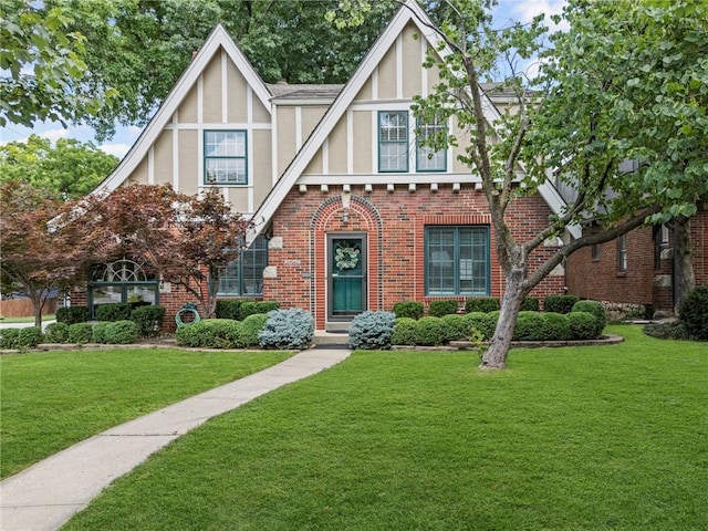 1296 W 72nd Ter, Kansas City, MO 64114 - tudor-style house with stucco siding, a front lawn, and brick siding