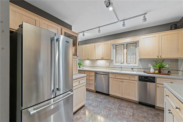 1296 W 72nd Ter, Kansas City, MO 64114 - kitchen with appliances with stainless steel finishes, light brown cabinetry, light countertops, and tasteful backsplash