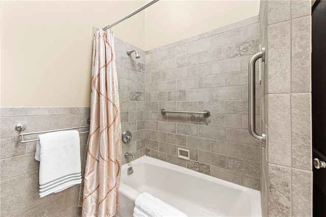 1296 W 72nd Ter, Kansas City, MO 64114 - bathroom featuring shower / tub combo and tile walls