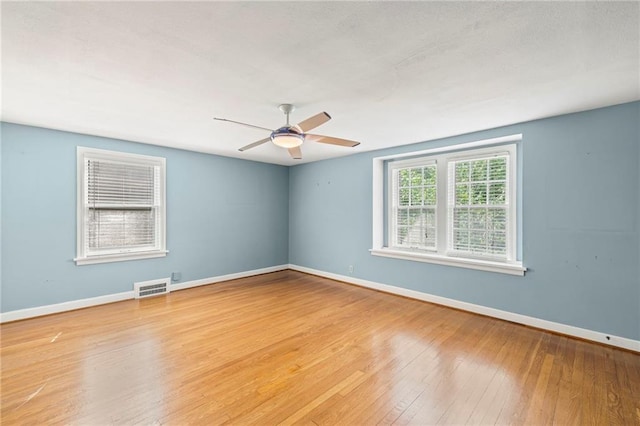 1296 W 72nd Ter, Kansas City, MO 64114 - empty room with wood-type flooring and ceiling fan