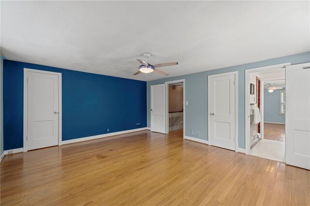 1296 W 72nd Ter, Kansas City, MO 64114 - unfurnished bedroom featuring light wood-type flooring and a ceiling fan