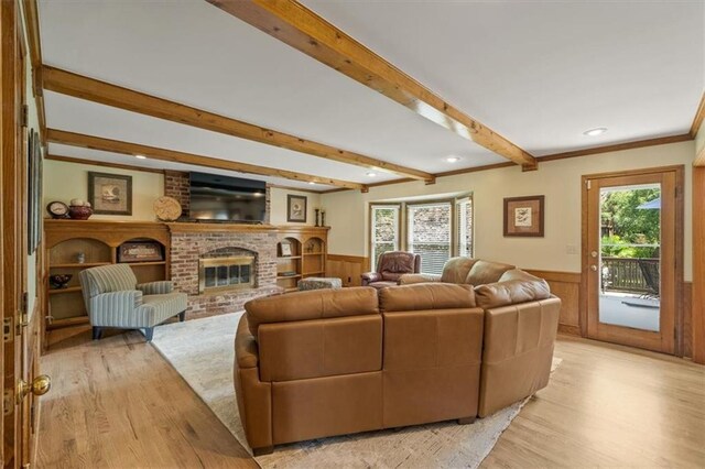 12147 Farley St, Overland Park, KS 66213 - living area featuring wainscoting, light wood-type flooring, beamed ceiling, a fireplace, and recessed lighting