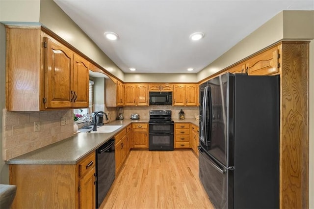12147 Farley St, Overland Park, KS 66213 - kitchen with black appliances, light wood-type flooring, brown cabinetry, tasteful backsplash, and recessed lighting