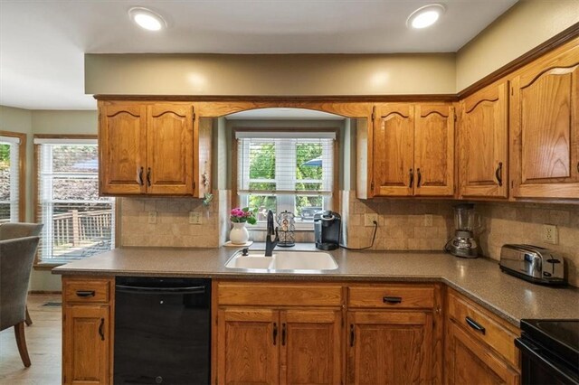 12147 Farley St, Overland Park, KS 66213 - kitchen featuring black appliances, brown cabinets, and decorative backsplash