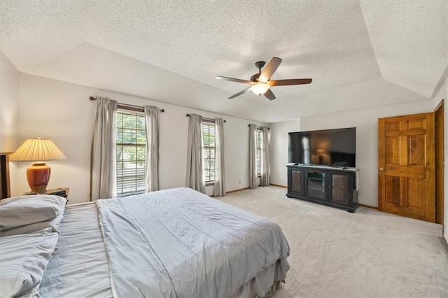 12147 Farley St, Overland Park, KS 66213 - bedroom featuring light carpet, a textured ceiling, a raised ceiling, and a ceiling fan