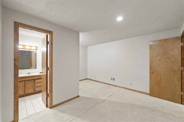 12147 Farley St, Overland Park, KS 66213 - spare room with light carpet, a textured ceiling, and recessed lighting