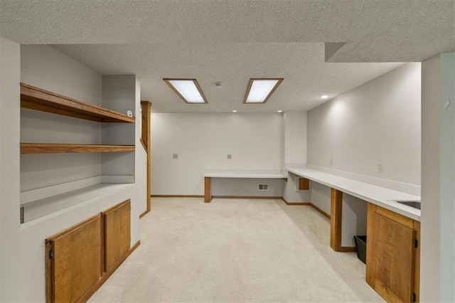 12147 Farley St, Overland Park, KS 66213 - unfurnished office featuring light carpet, a textured ceiling, and built in desk