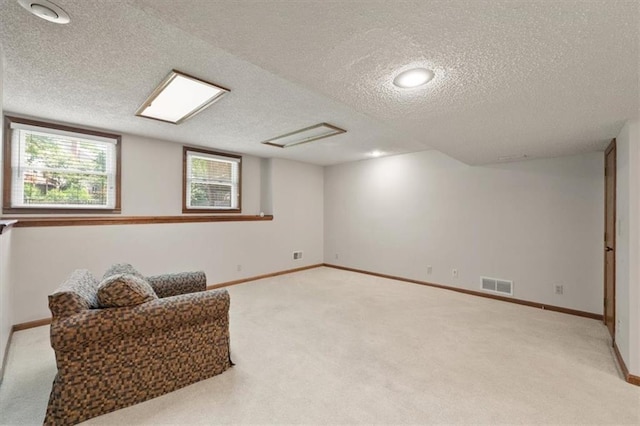 12147 Farley St, Overland Park, KS 66213 - below grade area with light colored carpet and a textured ceiling