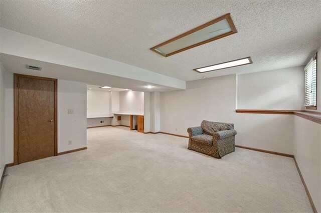 12147 Farley St, Overland Park, KS 66213 - below grade area featuring a textured ceiling and light colored carpet