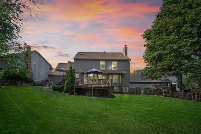 12147 Farley St, Overland Park, KS 66213 - back of property at dusk featuring a fenced backyard, a deck, and a chimney