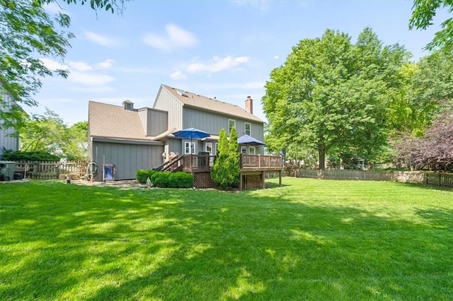 12147 Farley St, Overland Park, KS 66213 - back of property featuring a wooden deck, a fenced backyard, and a chimney