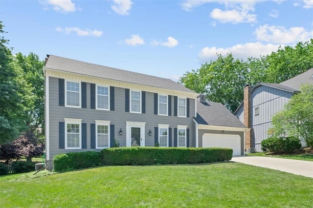 12147 Farley St, Overland Park, KS 66213 - colonial house with driveway, a front lawn, a garage, and a chimney