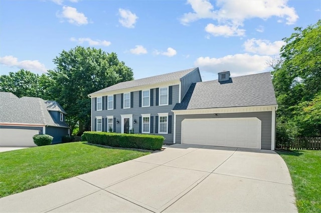 12147 Farley St, Overland Park, KS 66213 - colonial home featuring concrete driveway, a garage, and roof with shingles
