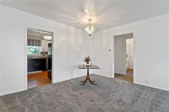 811 S Hickory St, Ottawa, KS 66067 - unfurnished room with carpet floors and a chandelier