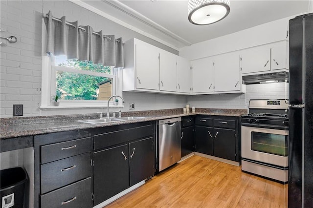 811 S Hickory St, Ottawa, KS 66067 - kitchen featuring stainless steel appliances, under cabinet range hood, white cabinets, dark countertops, and light wood-type flooring