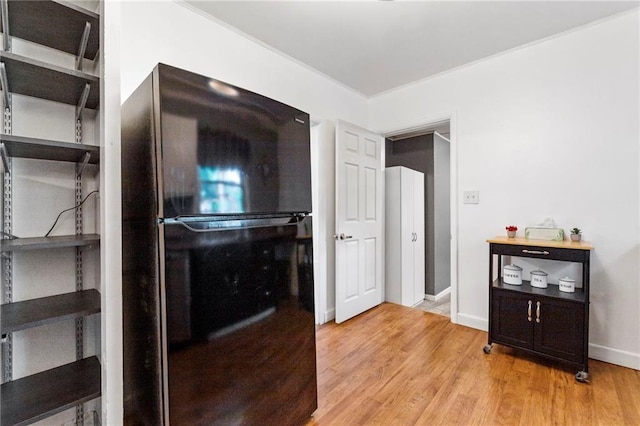 811 S Hickory St, Ottawa, KS 66067 - kitchen featuring freestanding refrigerator, open shelves, and light wood-type flooring