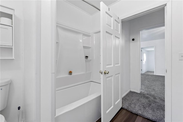 811 S Hickory St, Ottawa, KS 66067 - bathroom featuring washtub / shower combination and wood finished floors