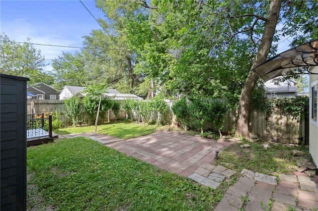 811 S Hickory St, Ottawa, KS 66067 - fenced backyard with a patio area