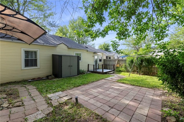 811 S Hickory St, Ottawa, KS 66067 - fenced backyard with a patio and a storage shed