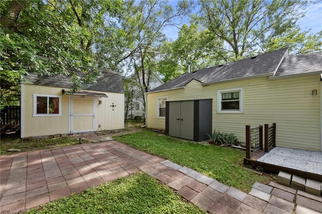 811 S Hickory St, Ottawa, KS 66067 - view of green lawn featuring a storage shed and a patio area