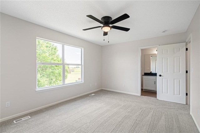 32625 W 174th St, Gardner, KS 66030 - unfurnished bedroom with multiple windows, carpet, connected bathroom, and ceiling fan