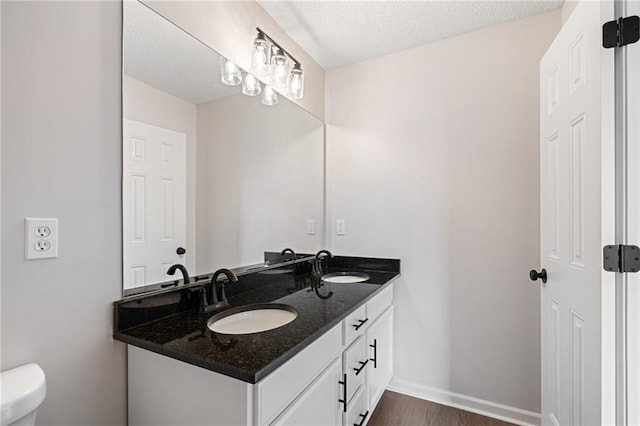 32625 W 174th St, Gardner, KS 66030 - bathroom featuring double vanity, wood finished floors, and a textured ceiling