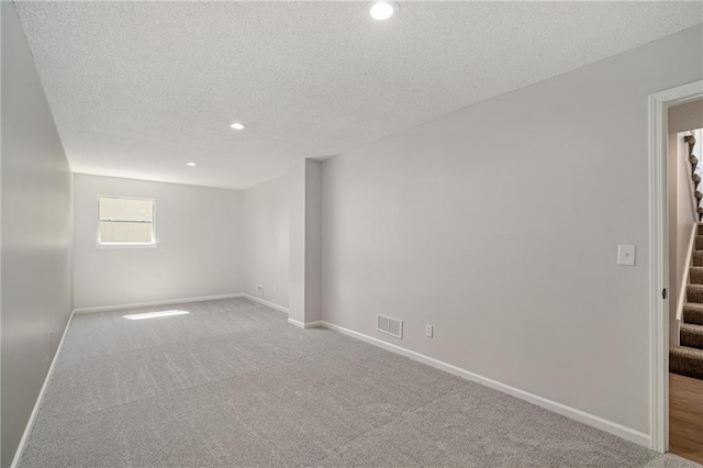 32625 W 174th St, Gardner, KS 66030 - empty room featuring stairway, a textured ceiling, carpet, and recessed lighting