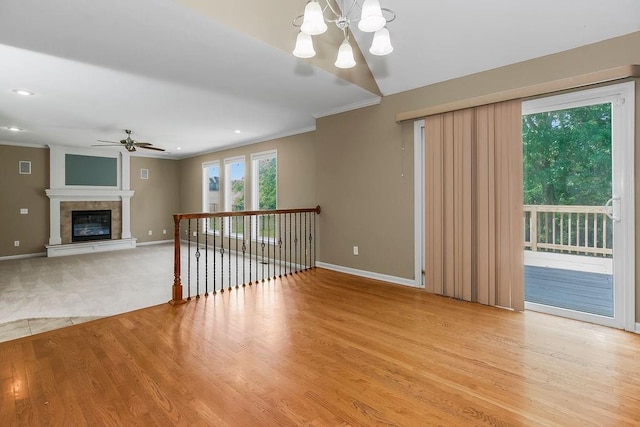 701 Tomahawk Ct, Smithville, MO 64089 - unfurnished living room with a ceiling fan, crown molding, a chandelier, light wood finished floors, and recessed lighting