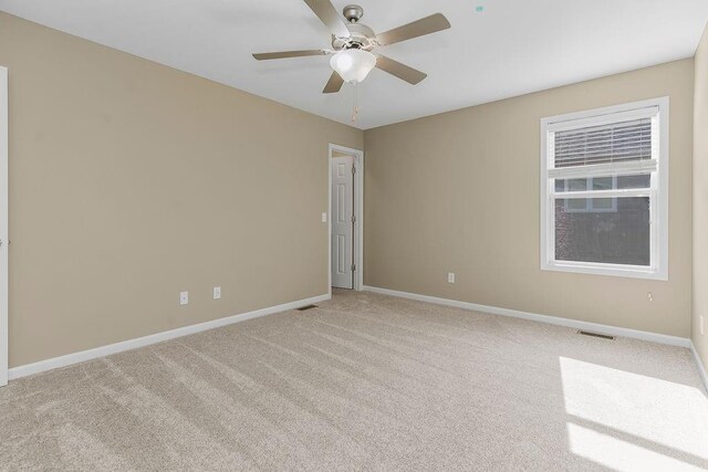 701 Tomahawk Ct, Smithville, MO 64089 - spare room featuring a ceiling fan and light carpet
