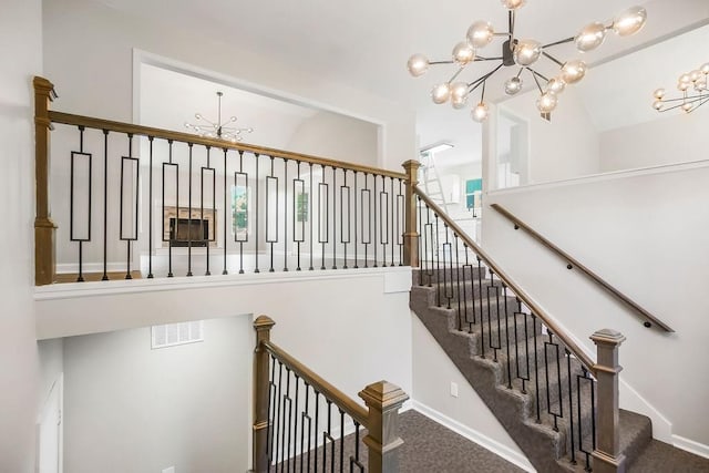 18201 W 157th Ter, Olathe, KS 66062 - staircase with a chandelier, carpet flooring, lofted ceiling, and plenty of natural light