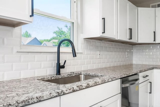 18201 W 157th Ter, Olathe, KS 66062 - kitchen featuring stainless steel dishwasher, white cabinetry, decorative backsplash, and light stone countertops