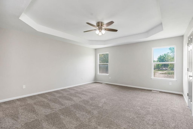 18201 W 157th Ter, Olathe, KS 66062 - carpeted empty room featuring a tray ceiling and ceiling fan