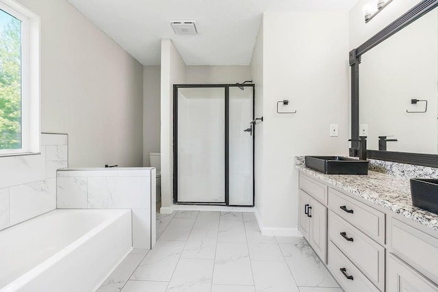 18201 W 157th Ter, Olathe, KS 66062 - full bath featuring marble finish flooring, vanity, a stall shower, a garden tub, and healthy amount of natural light