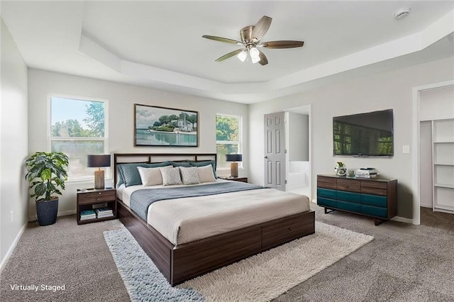 18201 W 157th Ter, Olathe, KS 66062 - bedroom with a tray ceiling, carpet flooring, and ceiling fan