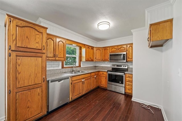 7 Hi View Ridge Dr, Archie, MO 64725 - kitchen with stainless steel appliances, ornamental molding, backsplash, brown cabinets, and dark wood finished floors