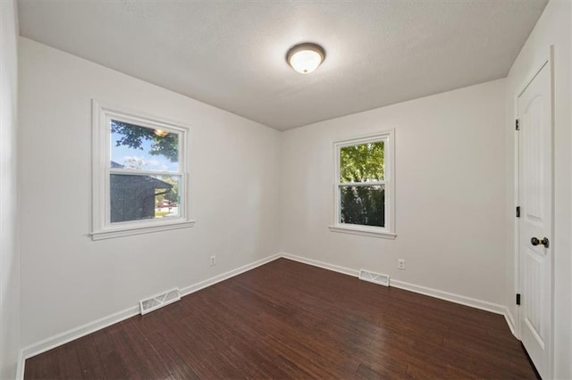 7 Hi View Ridge Dr, Archie, MO 64725 - unfurnished room with dark wood-type flooring and a textured ceiling