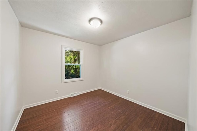 7 Hi View Ridge Dr, Archie, MO 64725 - empty room with dark wood finished floors and baseboards