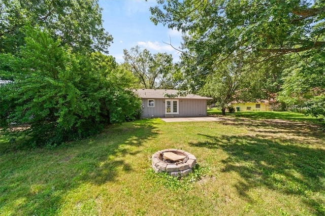 7 Hi View Ridge Dr, Archie, MO 64725 - view of green lawn with french doors, a fire pit, and a patio