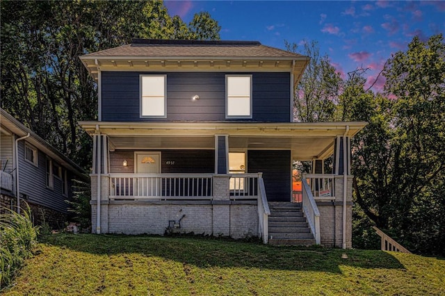 4937 Highland Ave, Kansas City, MO 64110 - traditional style home with a porch and a yard