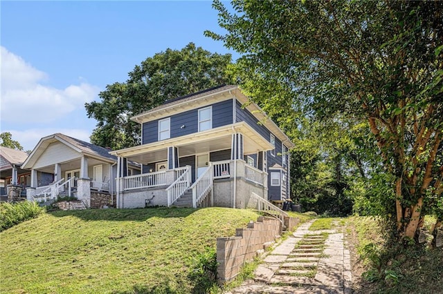4937 Highland Ave, Kansas City, MO 64110 - american foursquare style home with a front yard, covered porch, and stairway