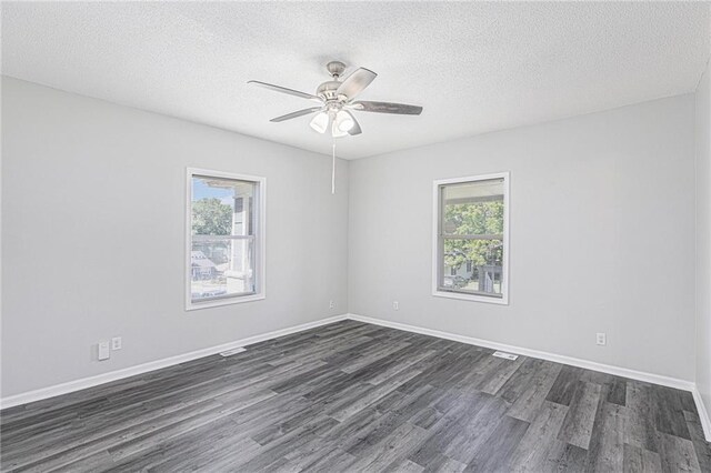 4937 Highland Ave, Kansas City, MO 64110 - empty room featuring dark wood finished floors, a textured ceiling, and a ceiling fan