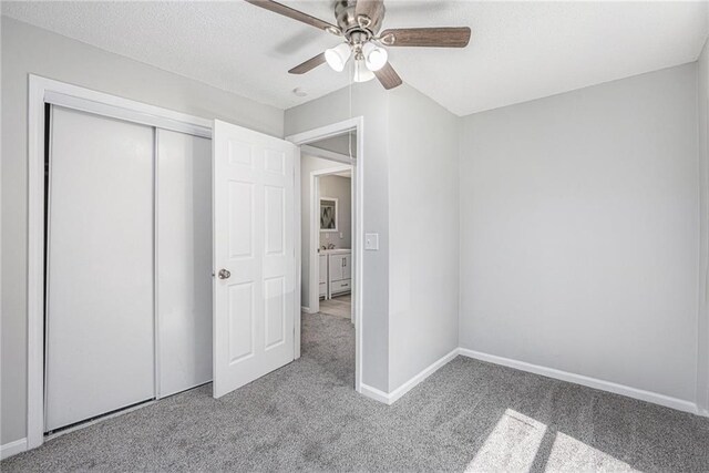4937 Highland Ave, Kansas City, MO 64110 - unfurnished bedroom featuring carpet, a closet, ceiling fan, and a textured ceiling