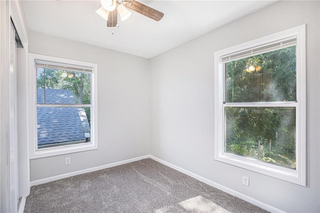4937 Highland Ave, Kansas City, MO 64110 - spare room with a ceiling fan and carpet