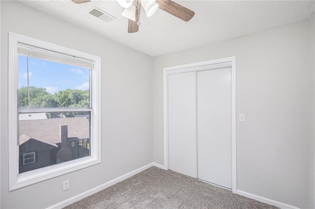 4937 Highland Ave, Kansas City, MO 64110 - unfurnished bedroom featuring carpet flooring, a closet, and ceiling fan